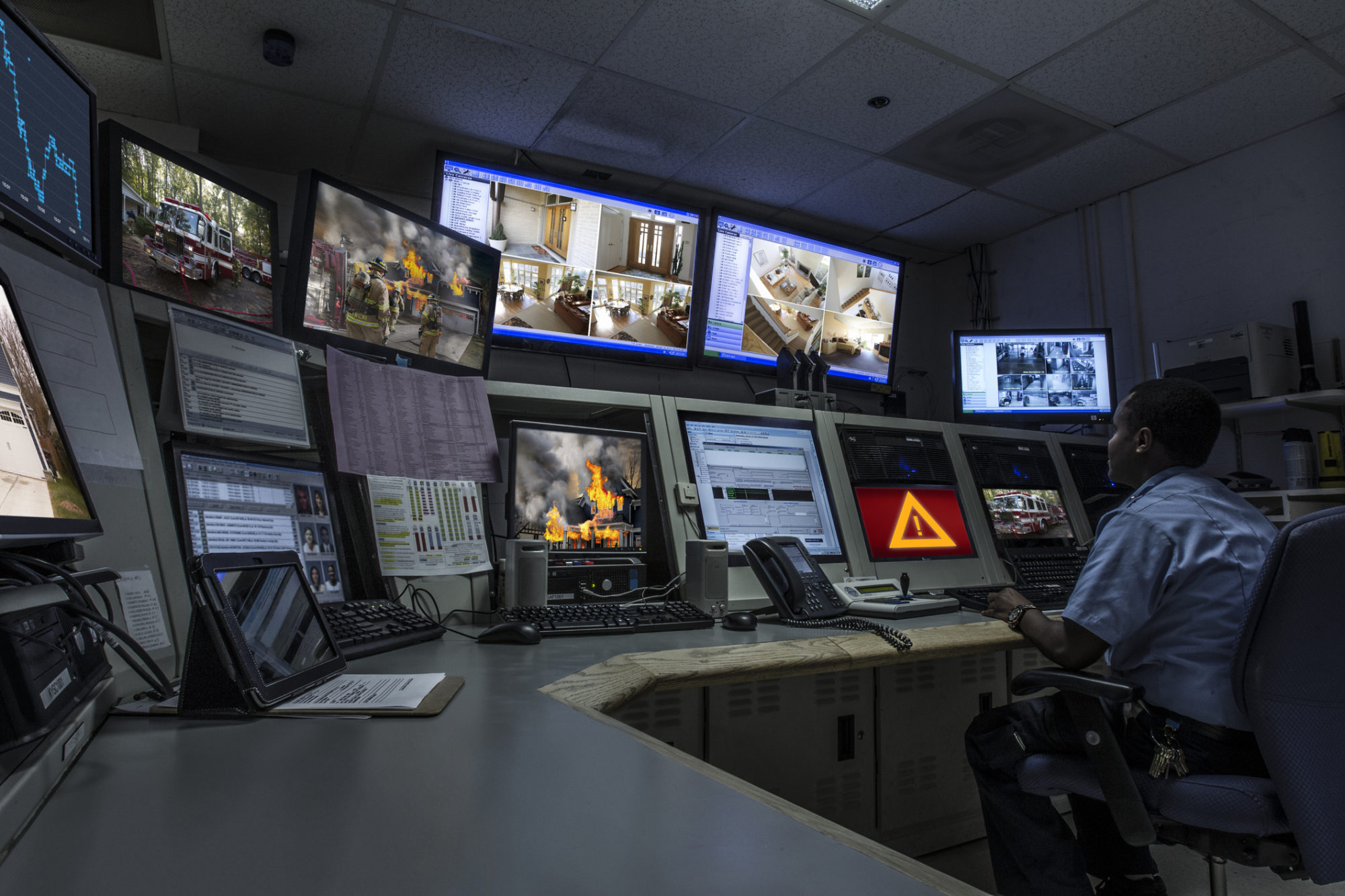 African American security officer working in control room